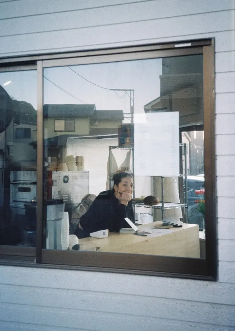 Burcu looking out through the bakery window