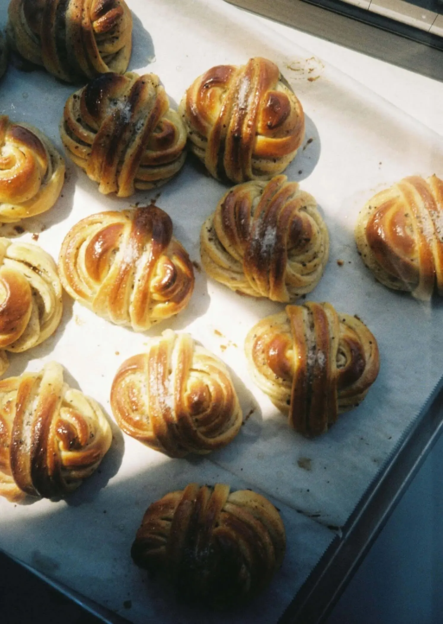 Freshly baked cardamom buns on a tray